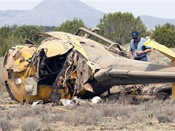 Medical Helicopter Crash: Renato Luts with the FAA looks over the scene of a medical helicopter that crashed south of Ash Fork, Arizona.